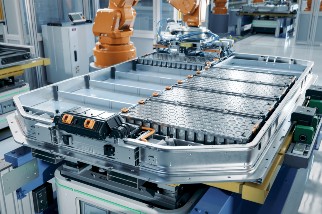 EV battery pack on a production line equipped with robot arms inside a modern factory